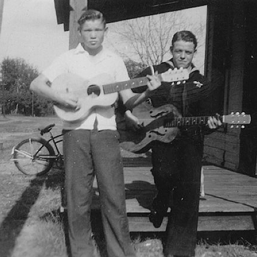 Vassar Clements As Young Man Picking Guitar on Front Porch